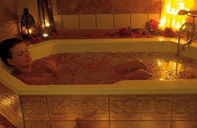 Rosenbad Frau nimmt ein Bad im Kerzenlicht