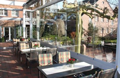 Wintergarten Tische vor Glaspanorama im Wintergarten